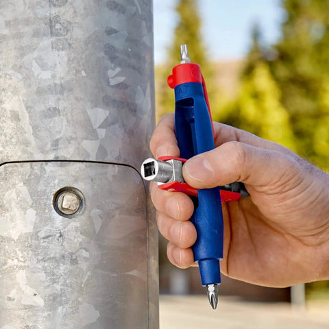Hand using Pen Style Control Cabinet Key with Swivel Four Profile Heads, Eight And One Eighth Inch Long for gas shutoff