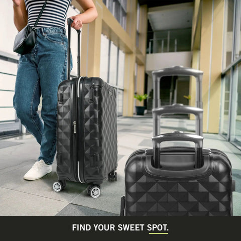Diamond Tower Collection Lightweight Hardside Luggage With Expandable Two Inch Space Eight Wheel Spinner Travel Case In Durable Diamond Textured Exterior Black 28 Inch Checked Suitcase For Effortless No Fuss Airport Glide being rolled by a person at an airport.