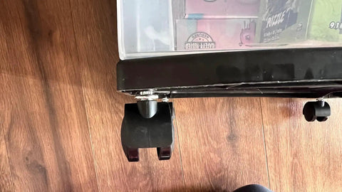 Close-up of installed black nylon caster with chrome stem on Sterilite drawer, part of Upgrade Your Sterilite Three Drawer Carts With Four Replacement One Point Five Inch Caster Wheels Black Nylon Construction With Chrome Stem That Swivels 360 Degrees For Smooth Movement And Versatile Use On American Plastic Storage Units By NUMBERNYC