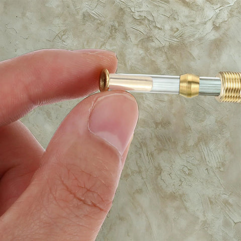 Brass 1/4 in tube ID compression fitting with brass insert for 4 mm OD tubing, gold color.