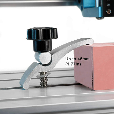 2 Pack Mini T Track Hold Down Clamps for CNC Routers installed on a 3018 Series machine, holding a pink block, close-up view