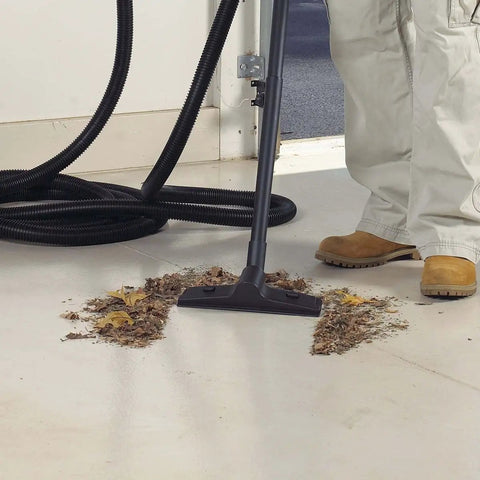 1.5 Inch Diameter Wet Dry Vacuum Accessory Kit with floor nozzle cleaning debris from a light-colored surface