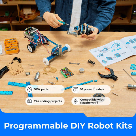 Makeblock mBot Ultimate 10-in-1 robot kit by Amazon on a worktable with blue modular parts and tools.
