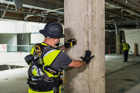 Worker installing A5 Concrete Expansion Anchor 5,000 Lbs Mbs Reusable Steel for Heavy Duty Anchoring on concrete pillar.