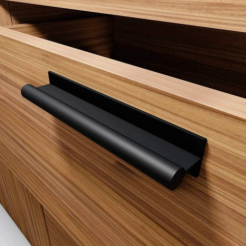 Black self adhesive edge finger pull door handle on wooden cabinet, part of a two pack, for glass, wood, metal, and plastic surfaces.