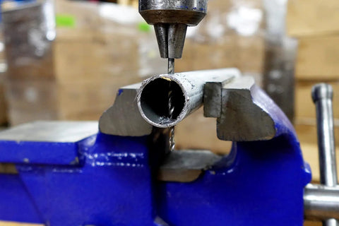 Premium High Speed Steel Wire Gauge Drill Bit No 44 in use, drilling into a metal pipe secured in a vice.