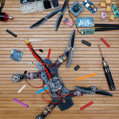 Drone build setup with carbon frame and electronic components, featuring 6 Pack M3 Aluminum Threaded Standoff Spacer Nuts 25mm Length Black