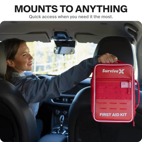 Woman installs Large Pro First Aid Kit for Car Travel and Home in vehicle, showcasing ease of access and organization.