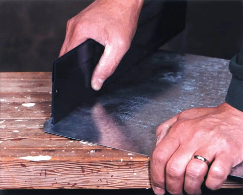 12-Inch Sheet Metal Folding Tool For HVAC Pros in use, bending metal on a wooden table, showcasing dual throat depth settings.