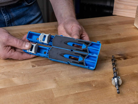 Hands holding Pocket Hole Jig XL for thick lumber and framing drills 1.5 to 3.5 inch stock, wooden table background