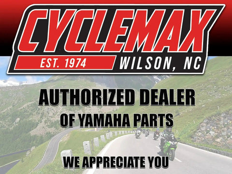 Authorized dealer Cyclemax sign with winding road and cyclists, located in Wilson, NC, established 1974, Yamaha parts emphasized.