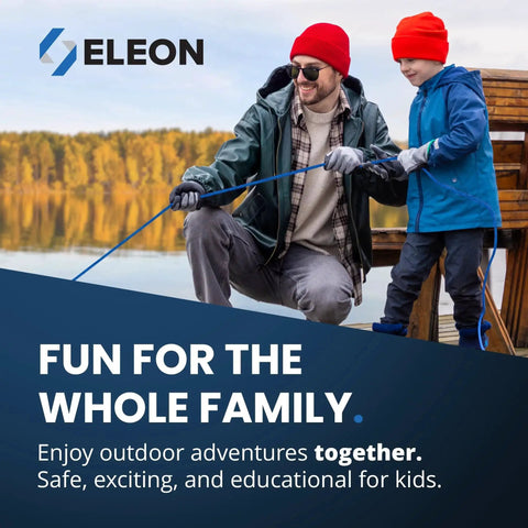 Father and son enjoying outdoor activity by water, wearing red hats and jackets, holding a blue rope.