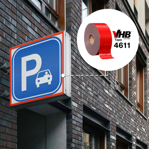 VHB double-sided acrylic foam tape 4611 dark gray used for parking sign mounting on building exterior.