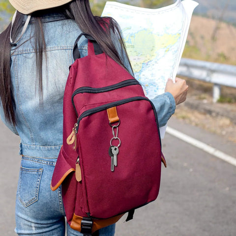 Traveler with a map and burgundy backpack, featuring 10 Pieces Heavy Duty Stainless Steel Quick Link Locking Carabiners For Keychains And Cages.