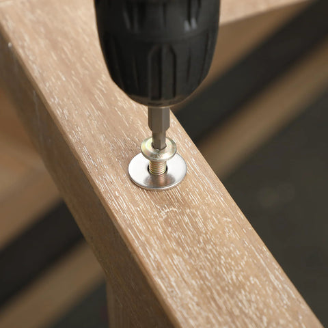 Stainless steel fender washer being driven into wood with a power drill