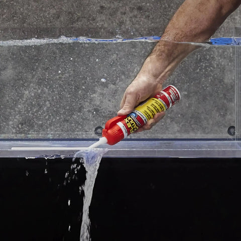 Demonstrating Waterproof Hybrid Caulk Sealant Paintable Indoor Outdoor No Caulk Gun Needed sealing leak in clear tank.