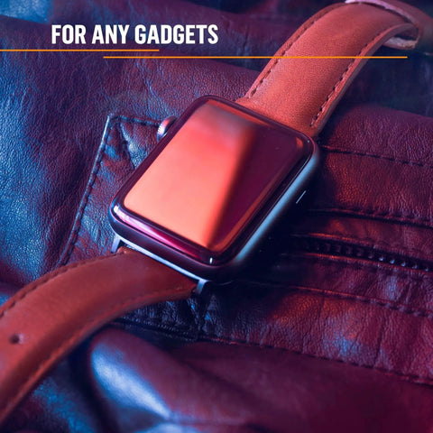 Smartwatch with leather band resting on a brown leather surface, reflecting ambient light.