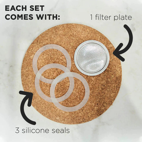 Milano Stovetop Espresso Maker Gasket Set With 3 Silicone Seals And 1 Replacement Filter Screen Kit displayed on cork surface.
