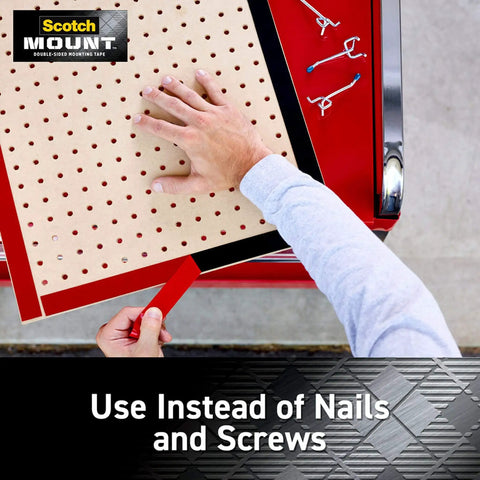 Applying double-sided heavy-duty mounting strips and tape to a pegboard, showing use instead of nails or screws for walls and outdoor use.