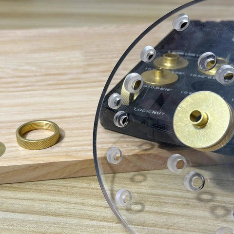 Close-up of Precision Brass Router Template Bushing Guide Set, 11 pcs with 1/4 inch shank, carrying case on wooden table