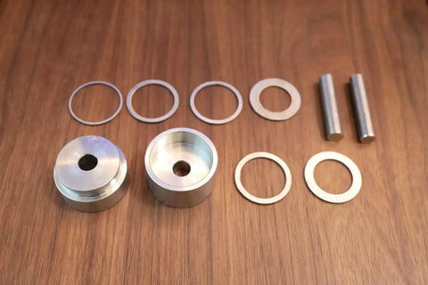 Coin Ring Puncher And Spacer Set For Jewelry Making With Six Spacer Rings In Inner Diameters Of 1.362, 1.276, 1.228, 1.209, 1.047, And 0.957 Inches on wooden table