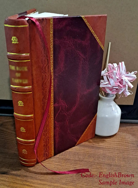 Front view of leather-bound book with burgundy and tan cover, gold tooling, pink ribbon bookmark.