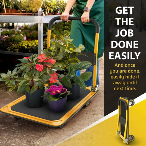 Person using Heavy Duty Foldable Push Cart Dolly With 660 Lb Capacity in a garden setting with plants, folded view shown.