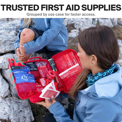 First aid kit in use with contents visible, Large First Aid Kit For Car Travel And Home With Zip Stitch Wound Closure Strips Emergency Kit