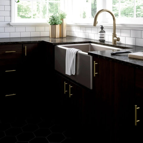 Modern kitchen with Satin Gold Cabinet Handles Set 30 Pack with Three Inch Center Holes installed on dark wood cabinets