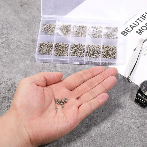 Person holding small screws with open Dope 1200-Piece Tiny Screw Kit With Phillips Pan Head Machine Screws in background