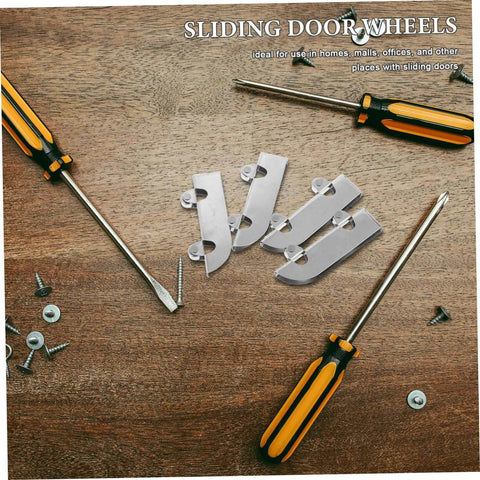 Heavy Duty Stainless Steel Sliding Door Bottom Wheel Set 4 Piece Track Rollers lying on a wooden surface next to screwdrivers and screws.