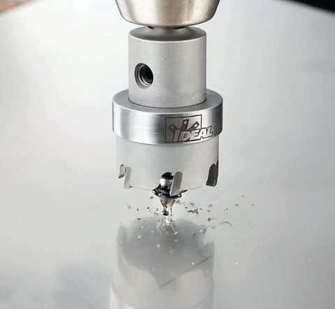 Close-up of TKO Carbide Tipped Hole Cutter Kit drilling sheet metal with Smooth Start Pilot Bit, creating precise, clean holes.