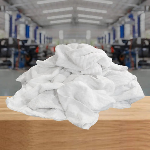 Premium White Terry Cloth Rags For Spills And Cleanup In The Garage Shop And Home Go To Multipurpose Cleaning Towels That Absorb Like Crazy In A 5 Lb Compressed Box For Industrial Use And Housekeeping, 18x18 inch towels displayed on a wooden table in a shop setting.
