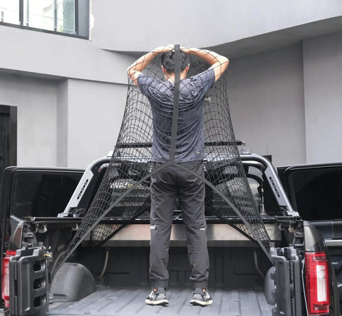 Person installing an elastic cargo net for truck bed and SUV to secure lightweight loads in place.