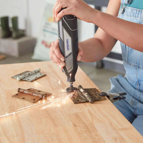 Using EZ Lock Starter Kit For Rotary Tools With One And A Half Inch Cut Off Wheels, cutting metal hinges with sparks flying.