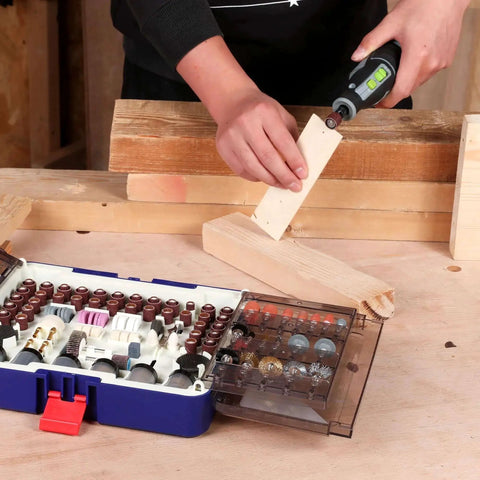 Person using rotary tool with the All Purpose Rotary Tool Accessories Kit With 476 Pieces For Cutting Sanding Grinding Carving Polishing Drilling Engraving Includes Sanding Papers And Bands Flap Wheels Cut Off Wheels Diamond Wheel Brushes And More Pro Grade WORKPRO on a wooden plank