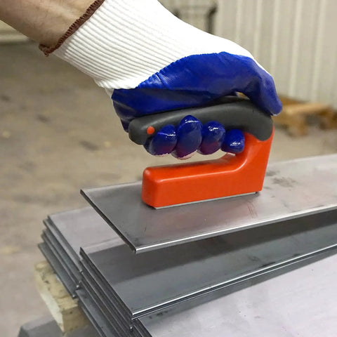 Person using 100 Pound Pull Magnetic Lifter With Ergonomic Handle Red to lift metal sheet