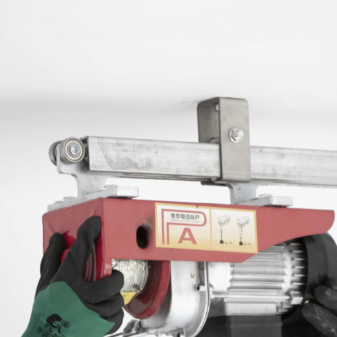 Hands installing Channel Trolley Track Hanger Bracket for 1-5/8 Inch Strut Channel on ceiling, showing hanger and attached motor.