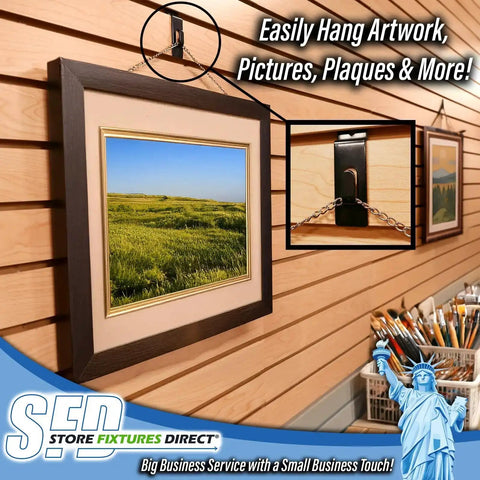 Black Slatwall Notch Hook 5 Pack Metal Picture Hanger holding framed artwork on slatwall display in retail setup