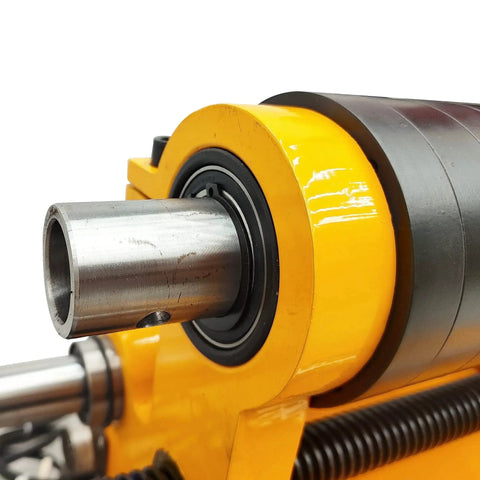 Close-up of a Portable Hole Drilling Machine For Excavators And Heavy Machinery By Breveltion. Metal components with yellow casing.