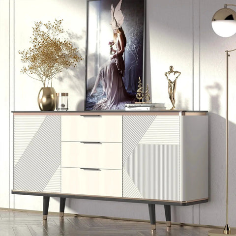 Modern white and gold cabinet with abstract wall art and decorative vase in elegant living room setting.