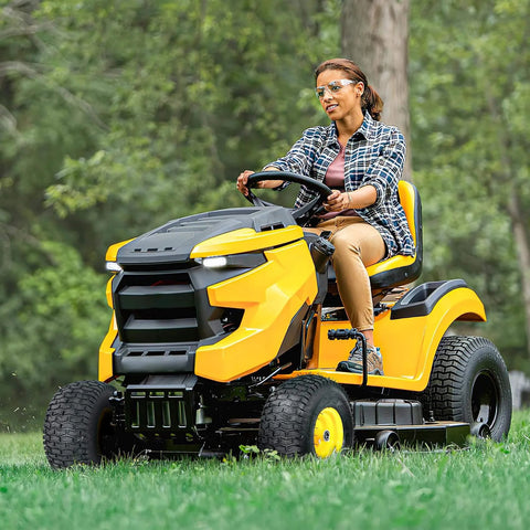 Person riding yellow lawn mower with 15x6.00-6nhs Beefed Up Lawn Mower Tires and Wheels Set Front Pneumatic Replacement