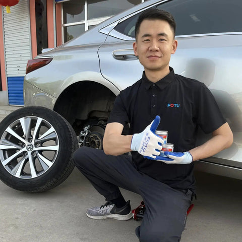 Mechanic holding Complete Brake Caliper Grease Kit with 661 Guide Pin Grease, 561 Anti Squeal, and 361 High Temp Copper Anti Seize near car