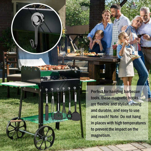 Outdoor barbecue cart with magnetic hooks holding utensils, family gathering in background