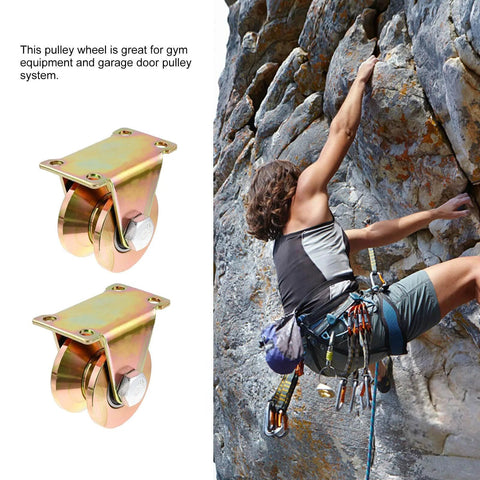 Heavy Duty Steel Pulley Block Pair With V Type Groove Wheel Sliding Gate Roller Track Wheel For Industrial Sliding Doors Hardware Designed To Minimize Vibration And Quietly Support Heavy Doors In Rail And Gate Systems next to a climber on a rock wall.