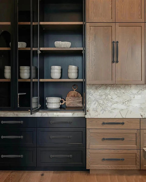 2 Pack 3 Inch Center Hole Matte Black Cabinet Pulls on kitchen cabinets in a modern setting.