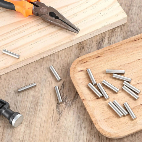 15 Pack One Quarter Inch Stainless Steel Shelf Peg Pins With Chamfered Ends For Easy Insertion, on wooden surface