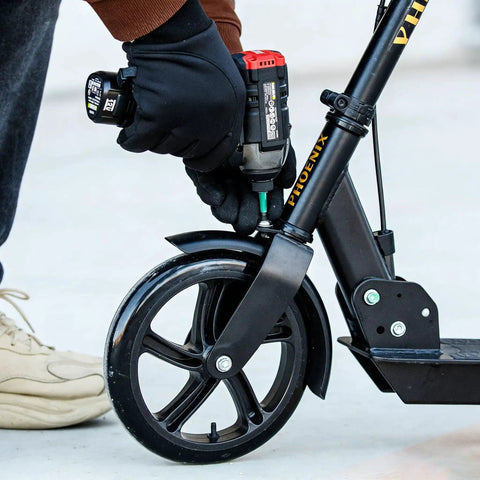 Using Tamper-Proof Torx Bit Set 27-Piece For Impact Drivers on a scooter wheel with impact driver