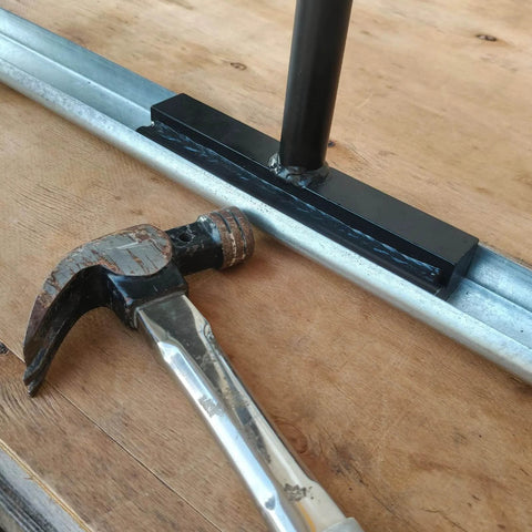 Vertical Track Repair Tool Set for Garage Doors with Heavy Duty Anvil Tools Exclusively Designed for 2 Inch Roller Track Rails Maintenance and Replacement Kit to Keep Doors Smooth Quiet and Easy to Access for DIY Homeowners shown with hammer and rail on wooden surface