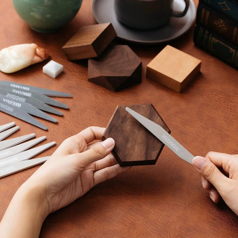Hands using 20 Pcs Sanding Sticks Set For Plastic Models And 3D Prints, Assorted Grits on a wooden hexagon.